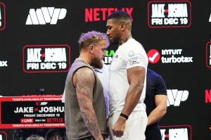 Jake Paul, left, and Anthony Joshua, right, face off during a news conference.