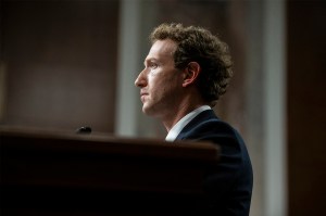 Meta CEO Mark Zuckerberg is wearing a suit and tie during a congressional hearing. He is seen from the side.