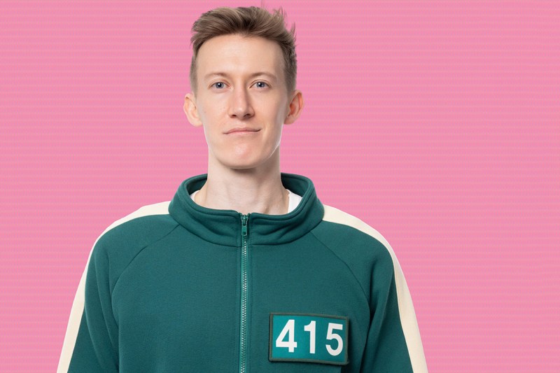 Eric Eldredge stands in his green Squid Game jumpsuit with the number 415 on his chest.