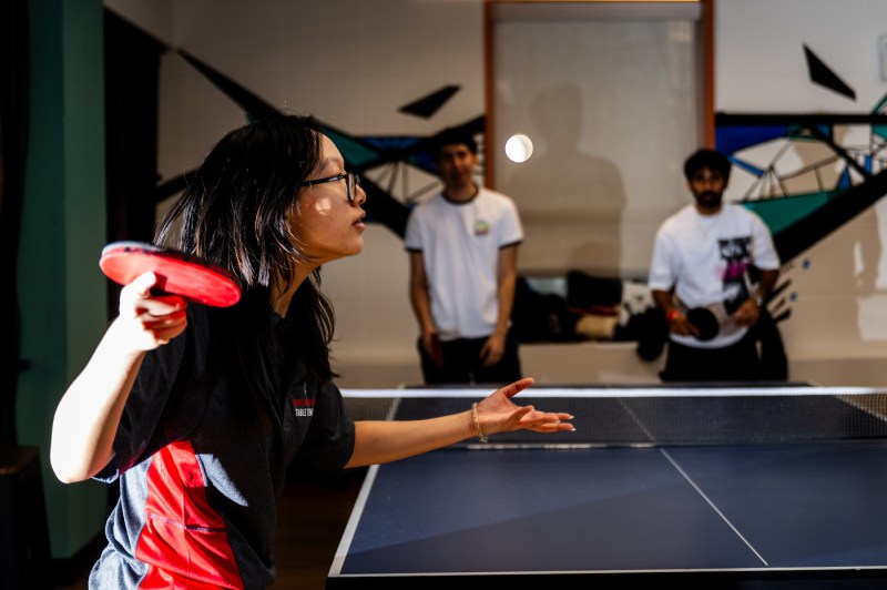 Members of the table tennis team play a game. 