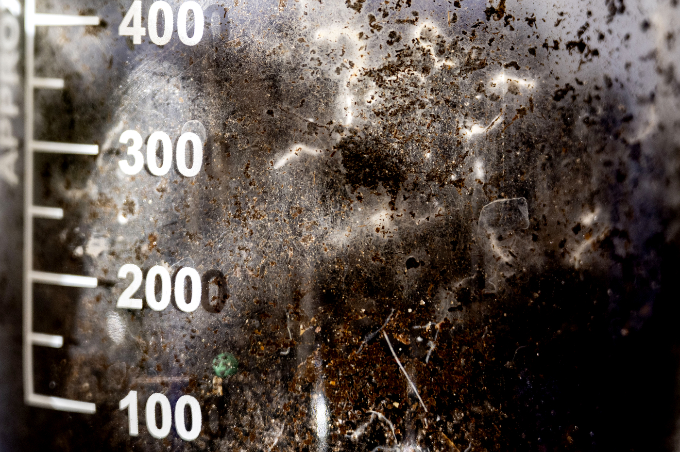 Close-up of a textured experimental surface marked with measurement lines during electronics testing.