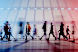 People walking past each other seen in motion blur.