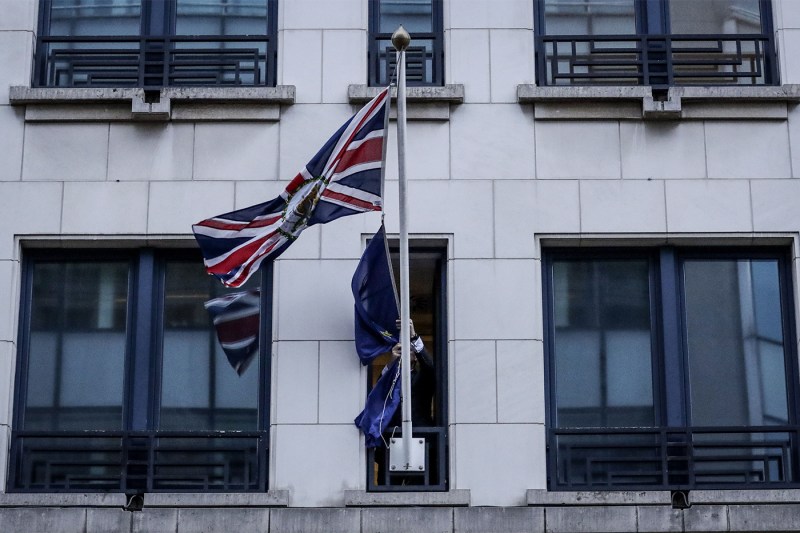 An official removes the European Union flag from the United Kingdom Representation to the EU building in Brussels, on Brexit Day, January 31, 2020