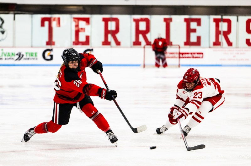 A Northeastern hockey player takes a shot on net at the Beanpot game.
