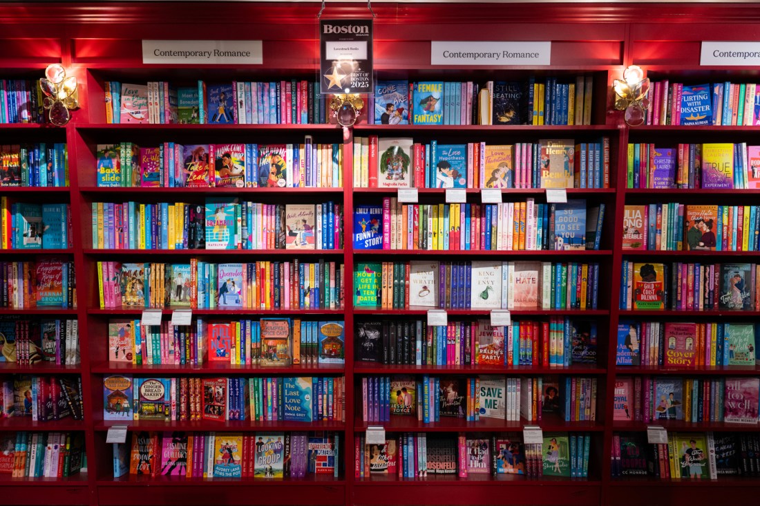 Crowded and colorful bookshelves. They are labelled Contemporary Romance.