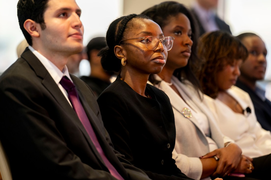 Students sitting in a row listening at the MLK ceremony.