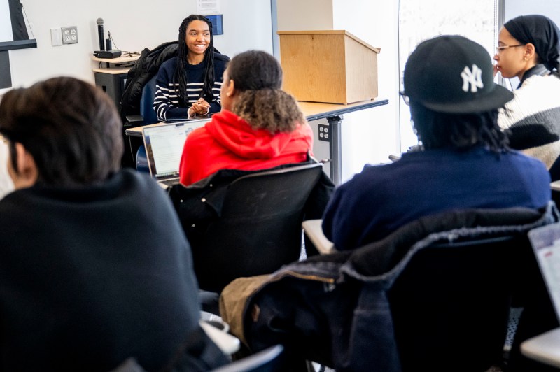 A classroom of students discusses with each other during a lesson.