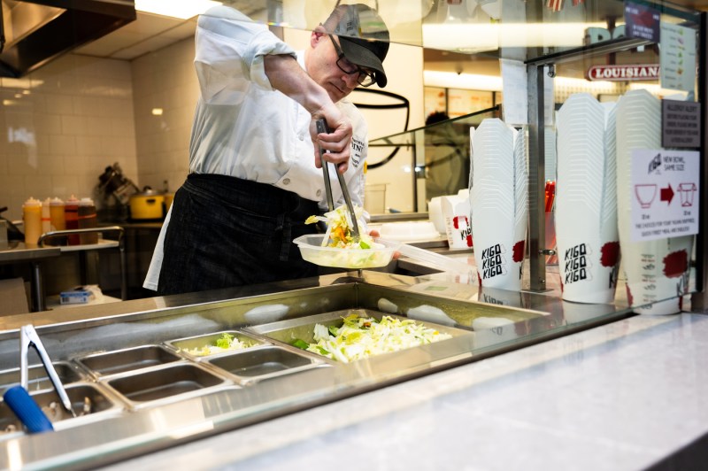 A food service worker prepares meals.