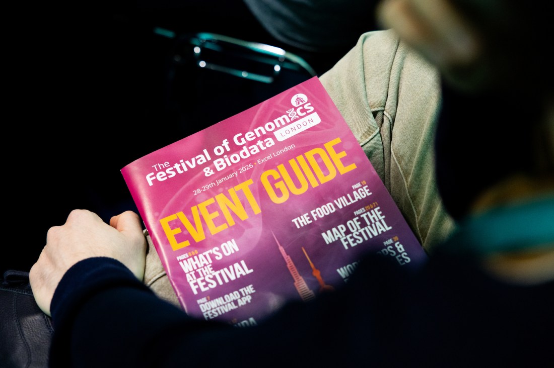 Event guide for the Festival of Genomics & Biodata on a person's lap