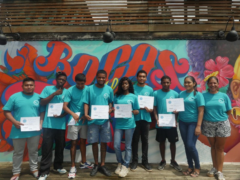Students with certificates of completion from a program from Give and Surf