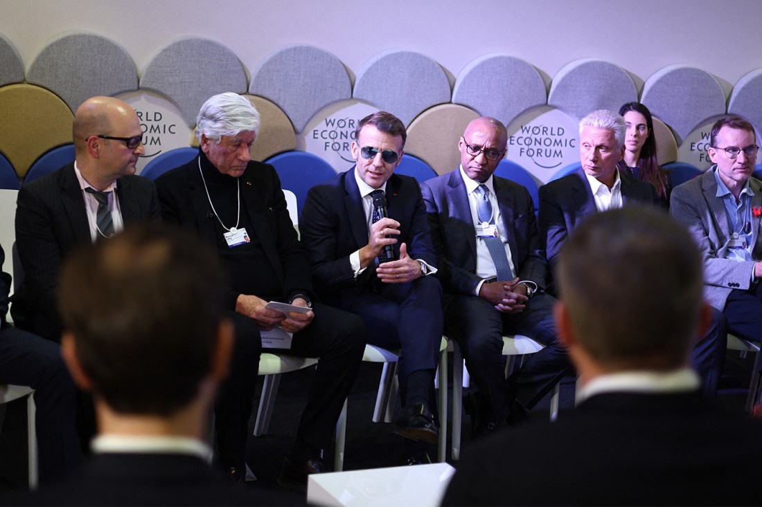 A group of European political leaders in suits and ties sit on cushioned chairs at the World Economic Forum.