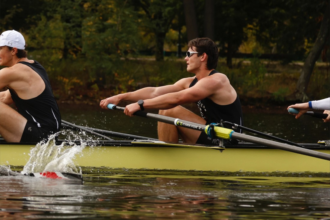 Edward Lopas rowing on the river with teammates