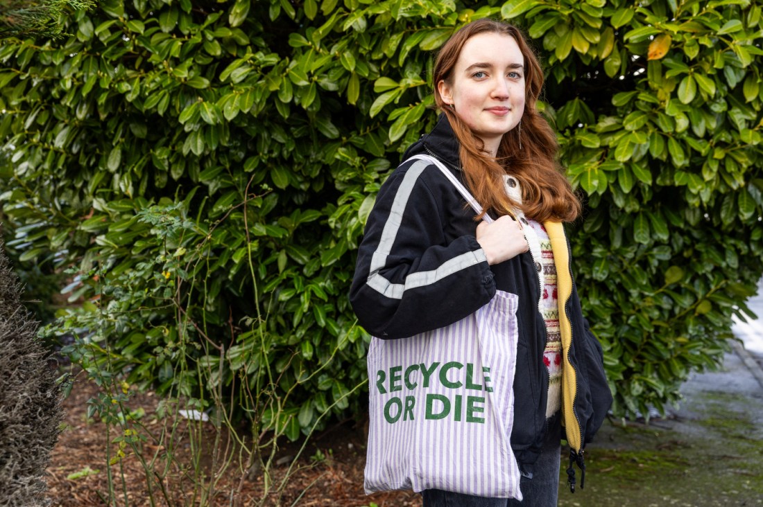 Woman poses with 'Recycle or die' tote bag