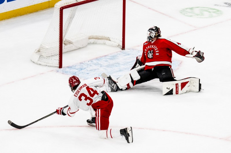 A BU hockey player attempts to score.