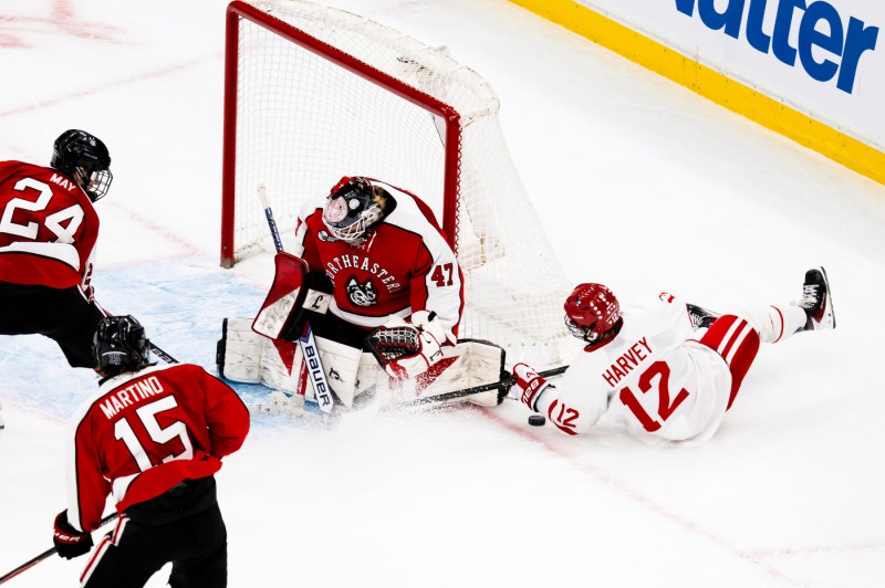 An action shot shows the Northeastern goalkeeper making a save.
