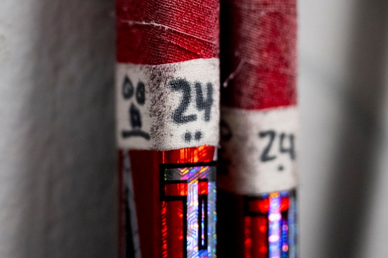 A close up of the signature of a Northeastern hockey player on the tape of a hockey stick.