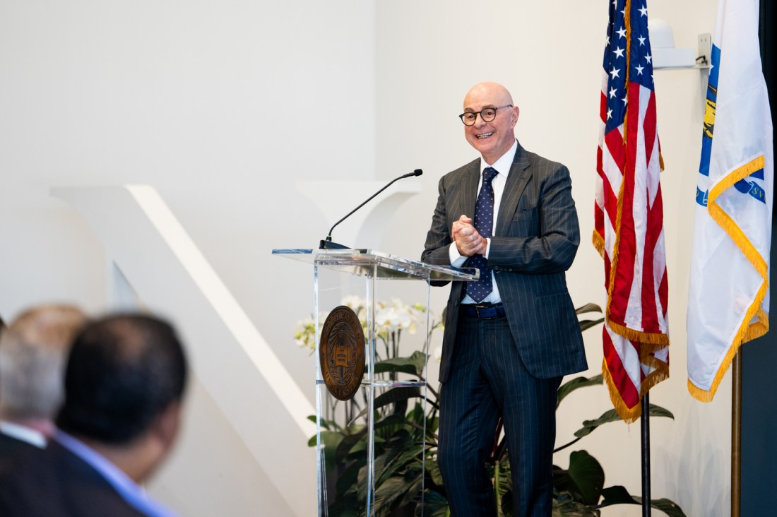 University president stands at a podium.