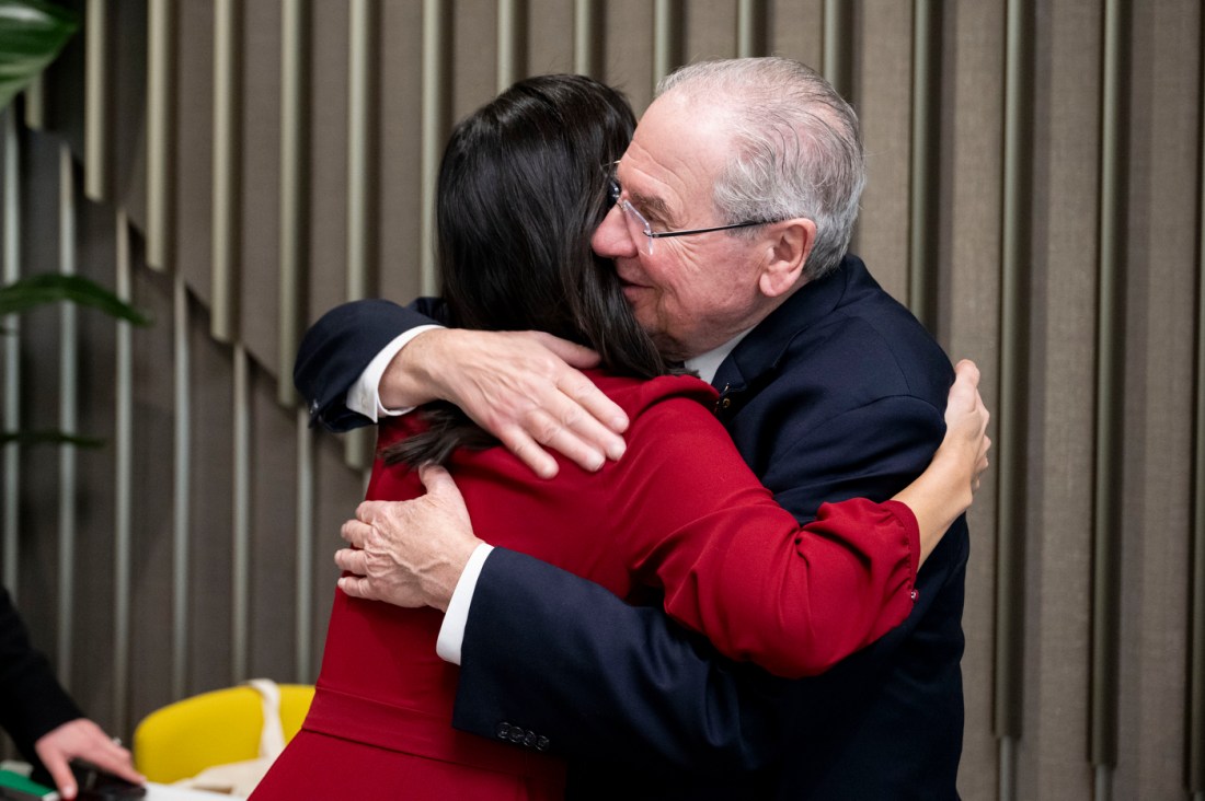 The mayor of Boston embraces a member of Northeastern's community in a hug.