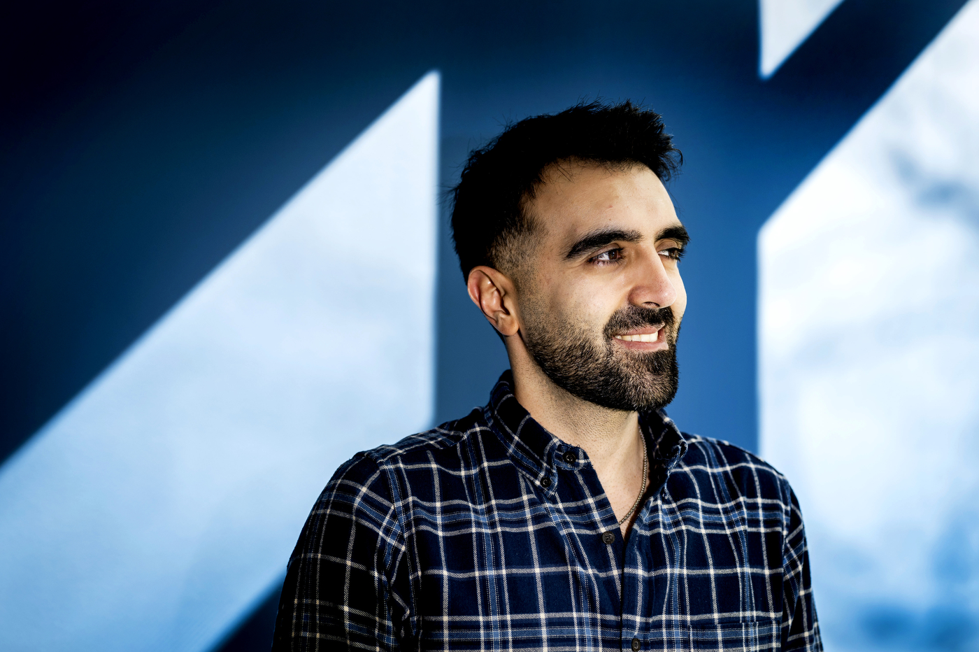 A portrait of a person dressed in a plaid shirt.