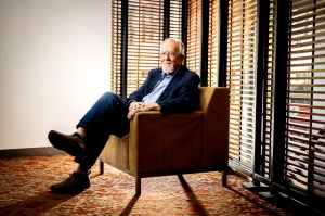 Ray Shurtleff in a suit sitting in an armchair in an office setting.