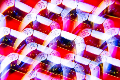 Multiple overlays of a white PlayStation 5 controller on a red background.