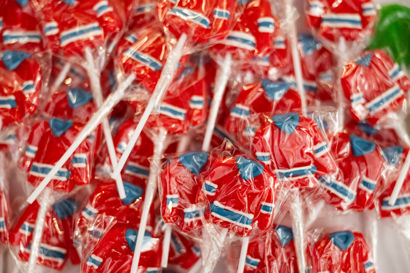 Small hockey jersey shaped treats wrapped in plastic on sticks.