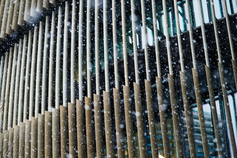 Exterior of a campus building as snow falls.