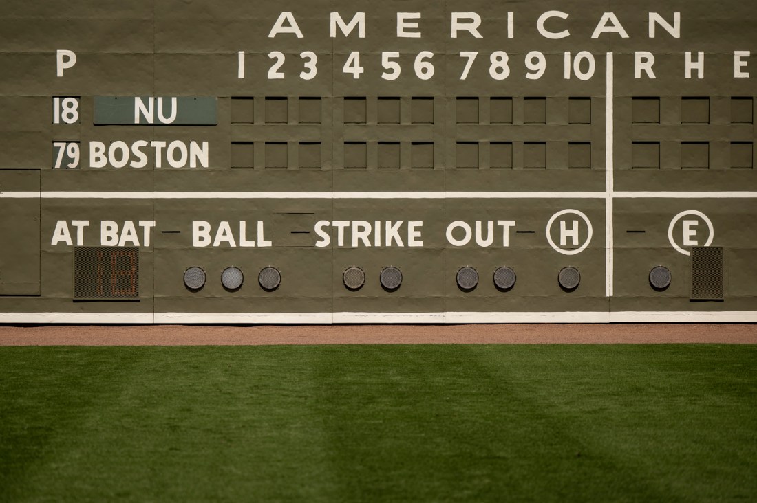 A scoreboard at jetBlue Park displays inning numbers, team names, and ball‑strike‑out indicators above the outfield grass.