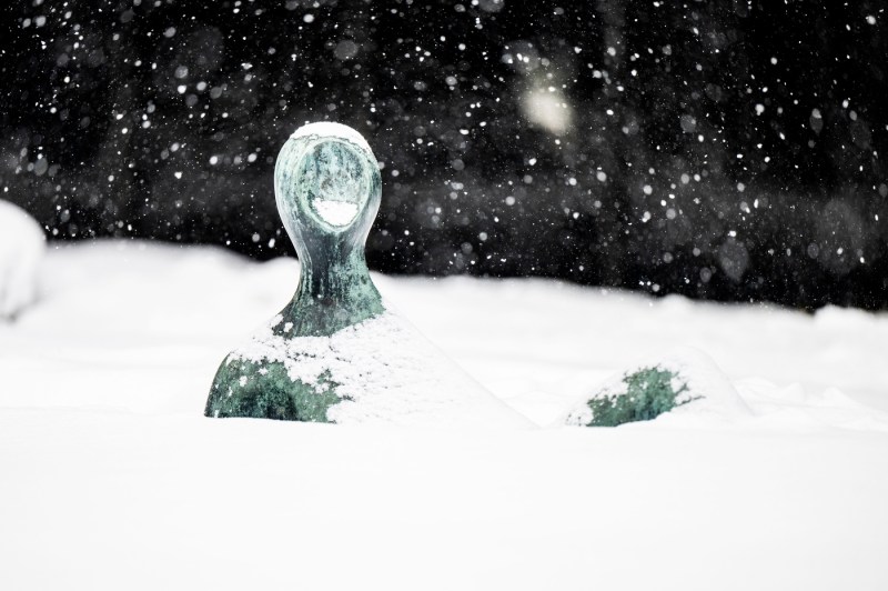 A close up of a structure covered in snow.