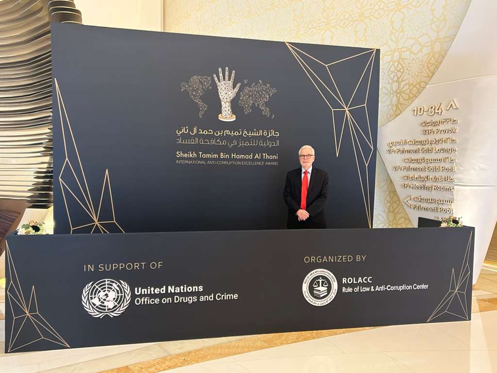 A man standing in front of a table with the UN logo and text on it.