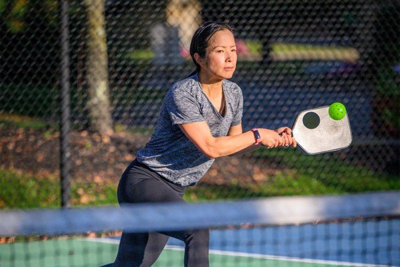 Cynthia Tow McPherson prepares to hit a backhand while playing pickleball.