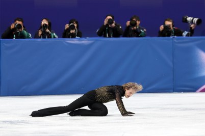 Ilia Malinin on the ice after falling over during a skating program at the Olympics.