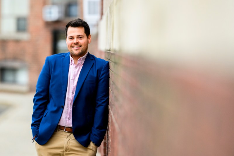 Portrait of Steve Warren wearing a pink shirt and a blue blazer.
