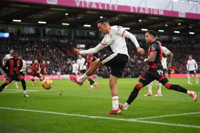 Trent Alexander-Arnold, a player for the Liverpool soccer team in Engalnd, kicking the ball on the pitch during a game.