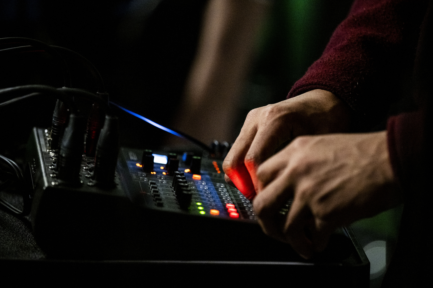 A crew member operates an audio mixing board during the taping of an NGN Podcast episode.