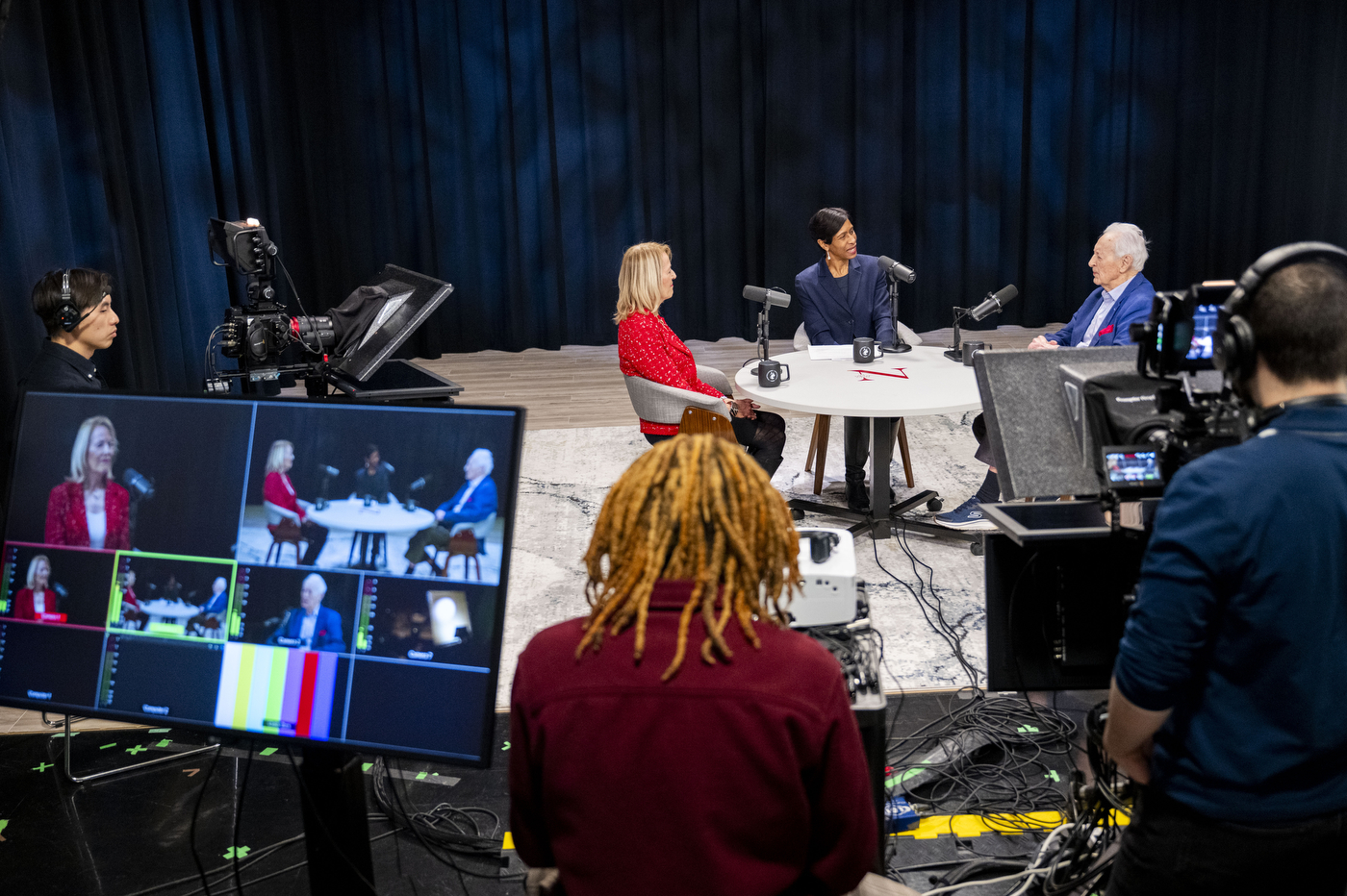 A film crew records Ann Simmons, Sheila Puffer and Daniel McCarthy at the NGN Podcast studio at Northeastern University.