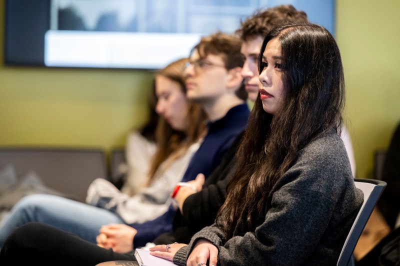 People sit in the audience of a student's Holocaust and Genocide Awareness presentation on her family history.