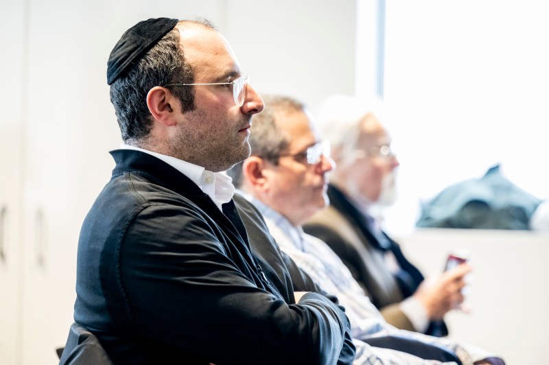 People sit in the audience of a student's Holocaust and Genocide Awareness presentation on her family history.