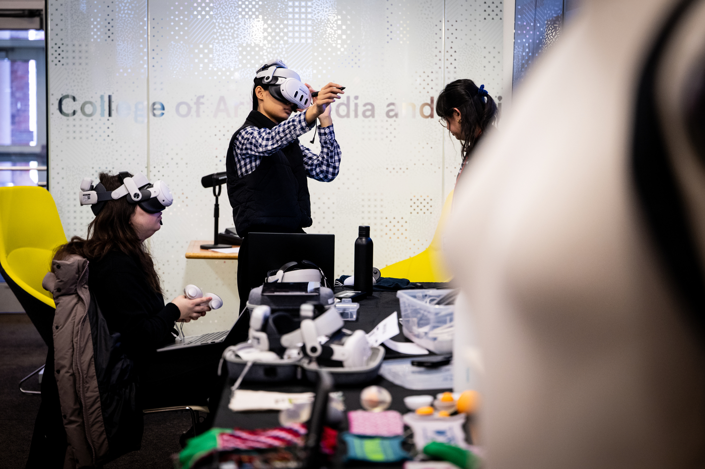 Two people wear VR headsets while testing a new reality art installation. 