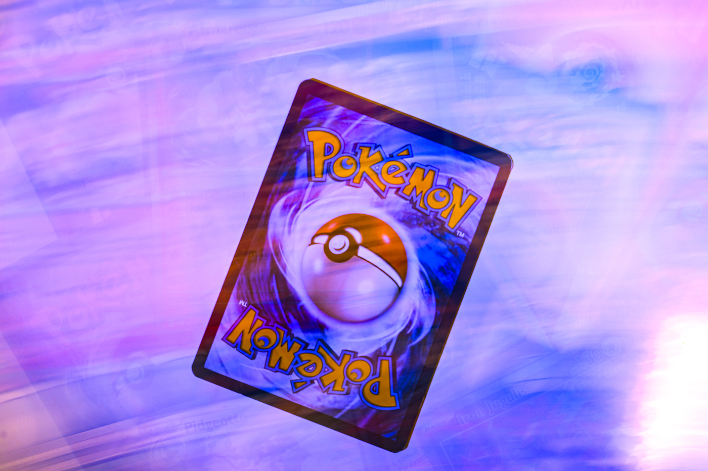 A Pokémon card face down on a white surface.