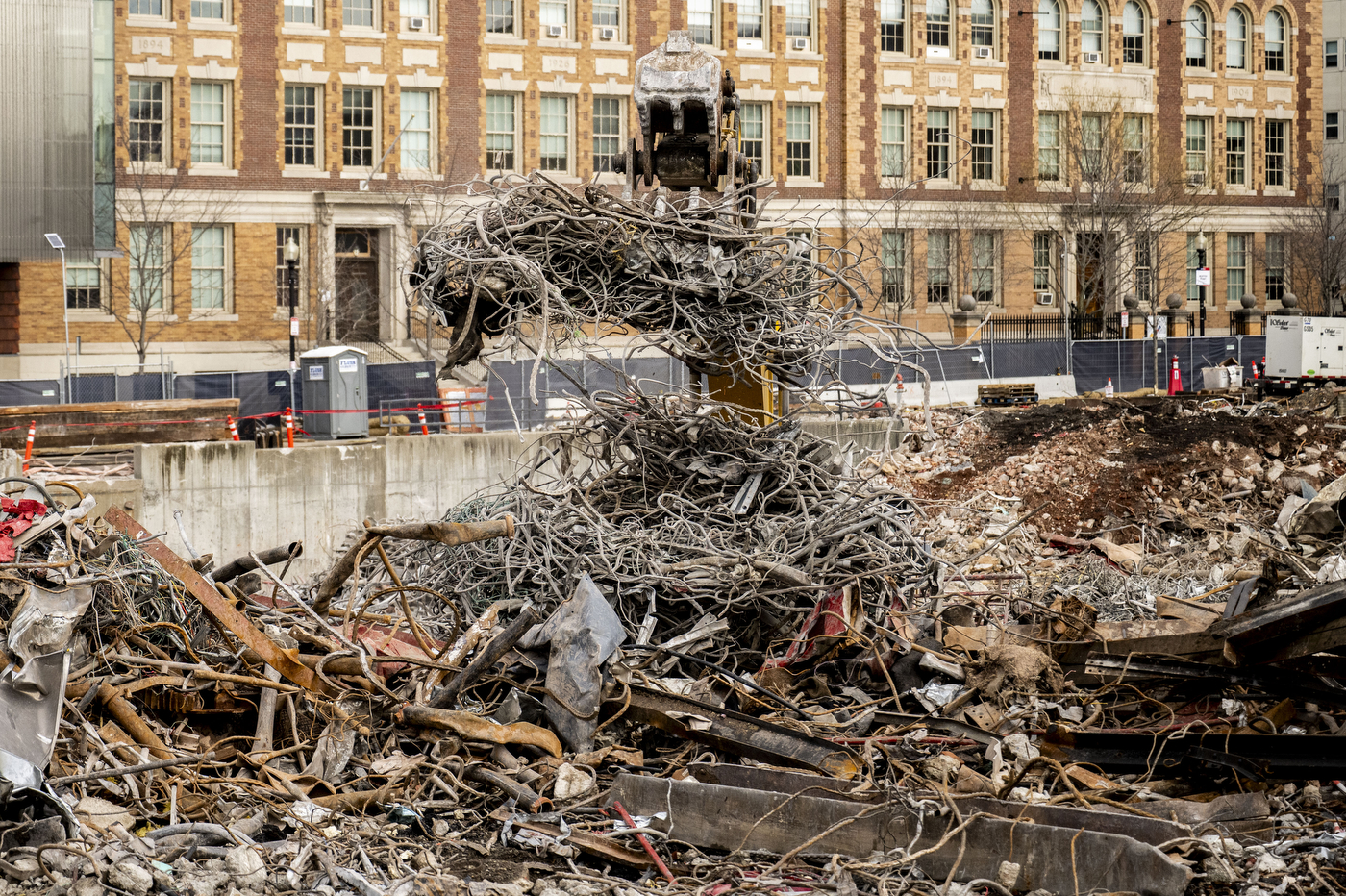 A construction vehicles is covered in tangled debris.