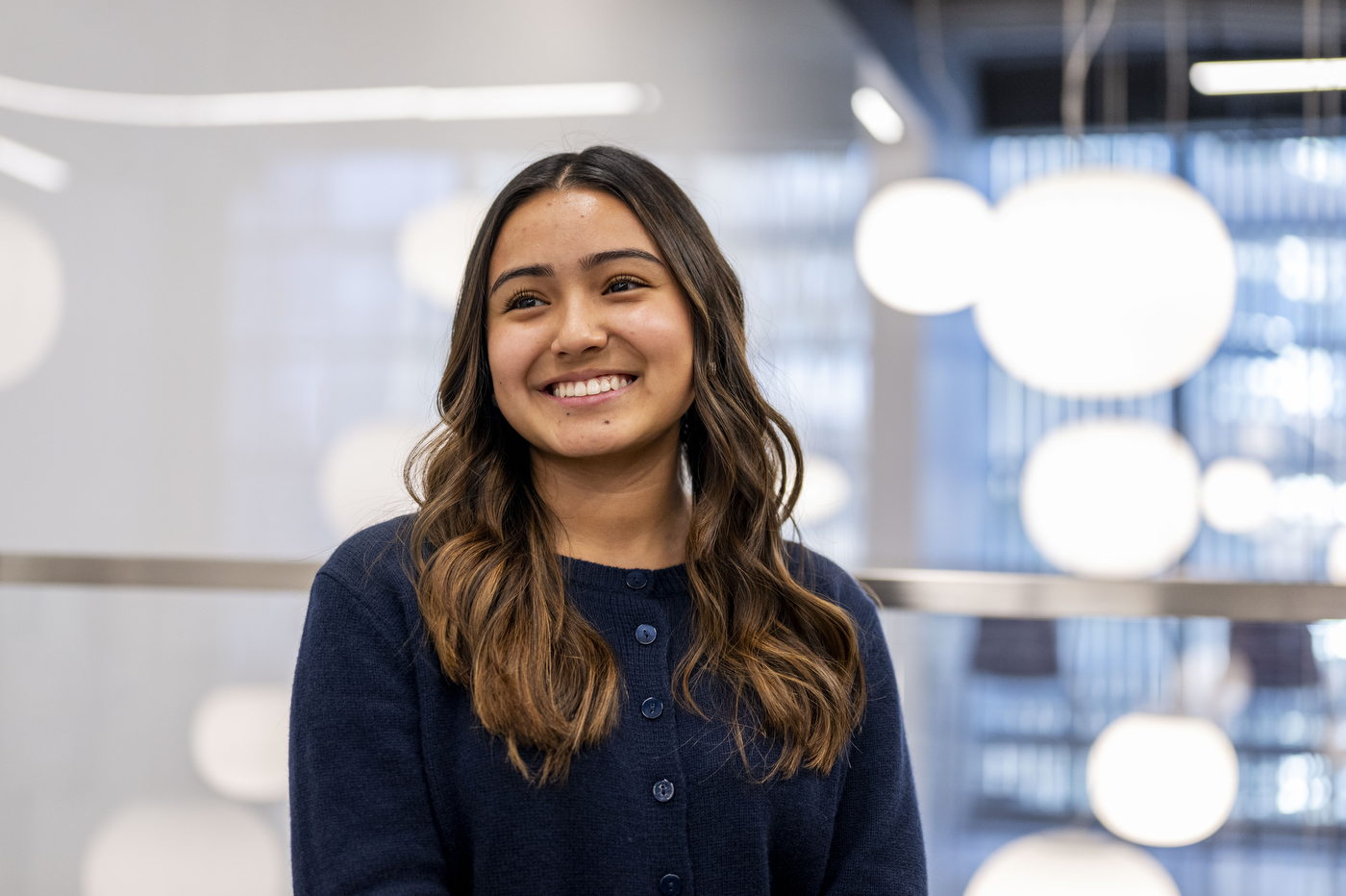 A portrait of a student who is looking off to her right and is smiling. 