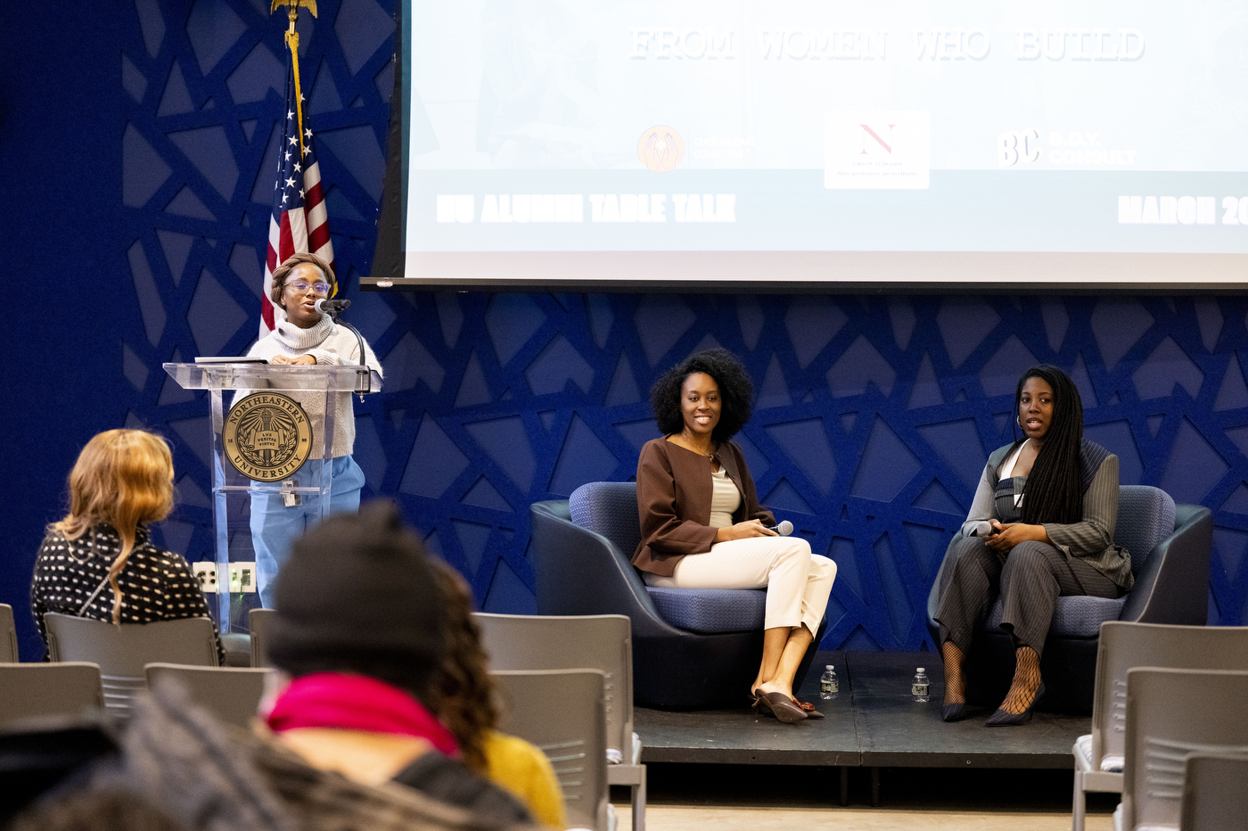 A wide shot of NU alums Cynthia Orofo and Adebukola Ajao on the stage. 