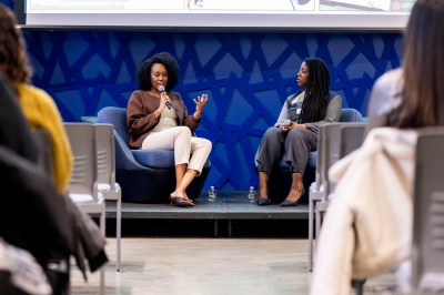 Northeastern Alumni, Cynthia Orofo and Adebukola Ajao, have a conversation during the Wellness & Wisdom from Women Who Build - NU Alumni Table Talk event held in the John D. O'Bryant African-American Institute.