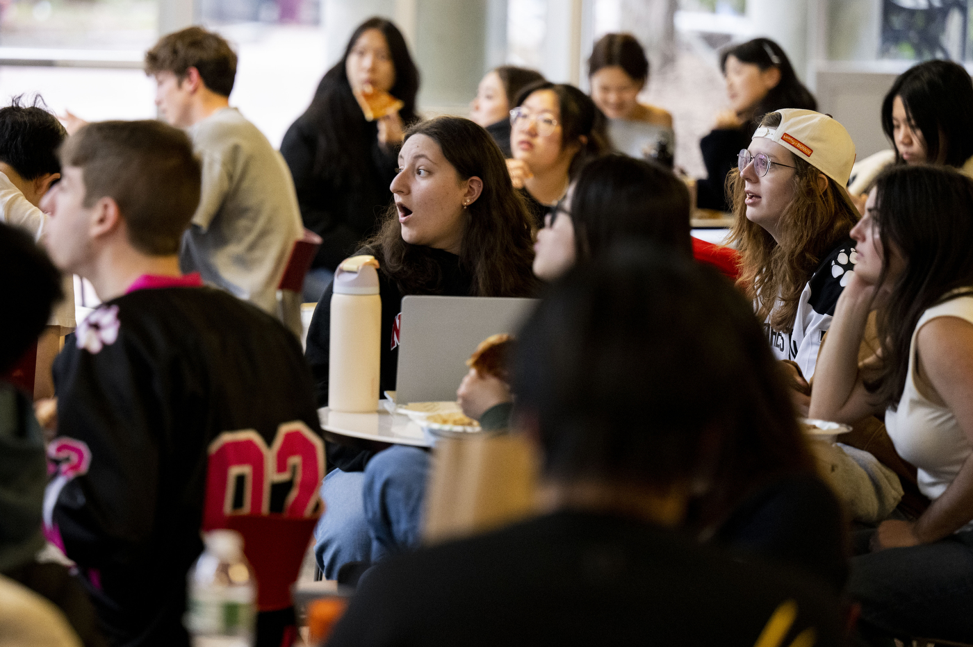 Students react as they watch the Frozen Four semifinal between Northeastern and Ohio State.