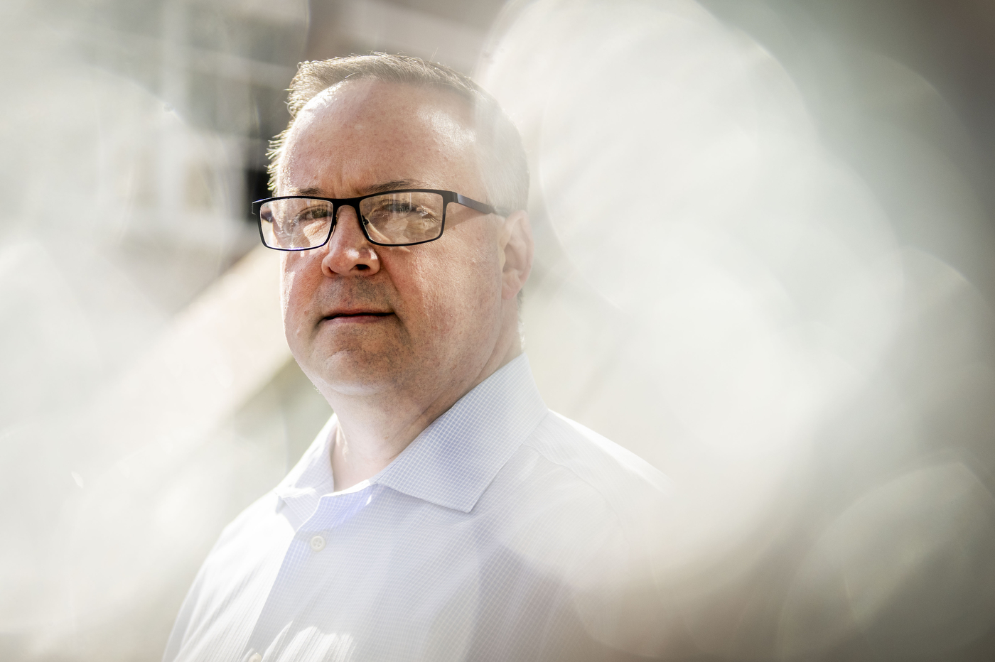 A portrait of a person. The background is blurred. 