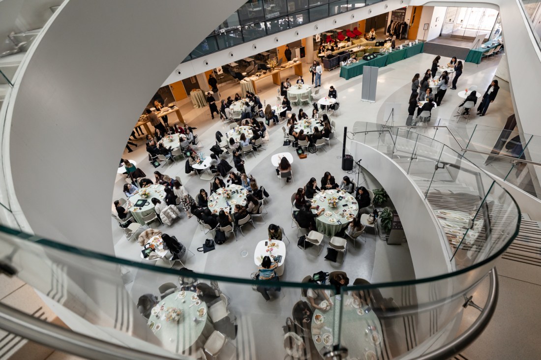 Overhead view of attendees seated at round tables in a large, modern atrium during the 2026 WISE Summit at Northeastern University.