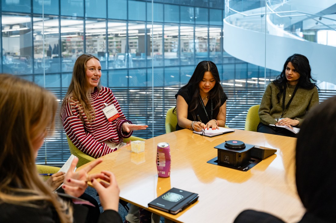 A small group of women sit around a table in discussion, taking notes during a breakout session at the 2026 WISE Summit.