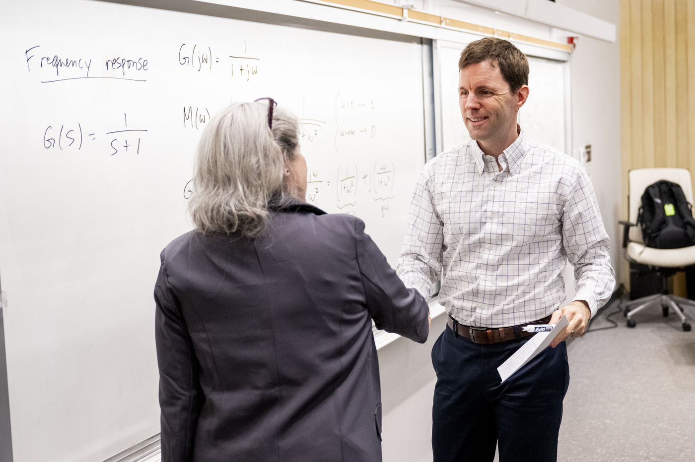 Provost Beth Winkelstein surprises professor Laurent Lessard with the University Excellence in Teaching Award during Lessard’s class in the Snell Engineering building on March 31, 2026. Photo by Matthew Modoono/Northeastern University