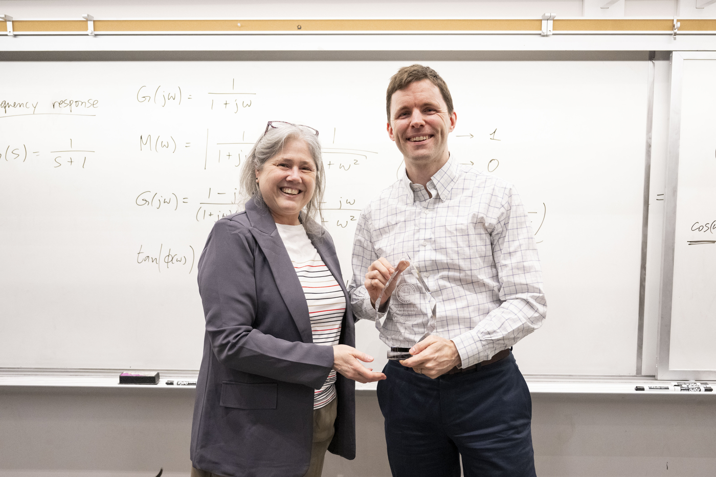 Provost Beth Winkelstein surprises professor Laurent Lessard with the University Excellence in Teaching Award during Lessard’s class in the Snell Engineering building on March 31, 2026. Photo by Matthew Modoono/Northeastern University